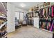 Large, well-organized walk-in closet with shelving, seating, and natural light at 7380 Abundant Harvest Ave, Las Vegas, NV 89131