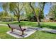 Picturesque community park with mature trees, a gazebo, a picnic table, and a walking path at 7310 Heggie Ave, Las Vegas, NV 89131