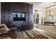 Cozy living room with built-in entertainment center and leather sofa at 2012 Poetry Ave, Henderson, NV 89052