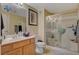 Bathroom with a shower, wood vanity, and updated fixtures at 9580 W Reno Ave # 238, Las Vegas, NV 89148
