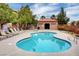 Community pool with lounge chairs and equipment storage at 9580 W Reno Ave # 238, Las Vegas, NV 89148