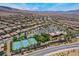 This aerial view shows the community, highlighting the pool, tennis courts, and parking at 2804 Josephine Dr, Henderson, NV 89044