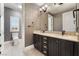 A stylish bathroom with a double vanity, toilet, and an open doorway at 2804 Josephine Dr, Henderson, NV 89044