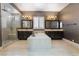 A luxurious bathroom featuring dual sinks, a soaking tub, and a glass-enclosed shower at 2804 Josephine Dr, Henderson, NV 89044