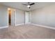A spacious bedroom with a ceiling fan and doors leading to a closet and other rooms at 2804 Josephine Dr, Henderson, NV 89044