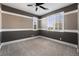 A neatly carpeted bedroom featuring dual windows and a modern ceiling fan at 2804 Josephine Dr, Henderson, NV 89044