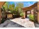 Private courtyard with tiled floor, stone archway, water feature and desert plants at 2804 Josephine Dr, Henderson, NV 89044