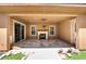Covered patio with fireplace, ceiling fan and travertine pavers at 2804 Josephine Dr, Henderson, NV 89044