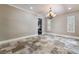 Dining room featuring stone flooring, a decorative chandelier, and windows with white shutters at 2804 Josephine Dr, Henderson, NV 89044