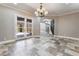 Dining room features stone tile flooring, chandelier, and a view of the outdoor patio and staircase at 2804 Josephine Dr, Henderson, NV 89044