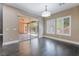 A dining room with sliding glass doors to an outdoor patio and windows with white shutters, hardwood floors at 2804 Josephine Dr, Henderson, NV 89044