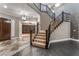 Foyer area with a wooden door, tile flooring, and a staircase with iron railings at 2804 Josephine Dr, Henderson, NV 89044