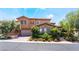 Two-story home featuring desert landscaping, stone accents, and a two-car garage in a sunny neighborhood at 2804 Josephine Dr, Henderson, NV 89044
