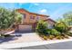 Two-story home featuring desert landscaping, stone accents, and a two-car garage at 2804 Josephine Dr, Henderson, NV 89044