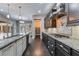 Kitchen featuring an island with granite countertop, stainless steel appliances, and dark cabinetry with hardwood floors at 2804 Josephine Dr, Henderson, NV 89044