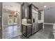 Kitchen area featuring dark cabinets, stainless steel appliances, granite countertops, and an entry to an outdoor patio at 2804 Josephine Dr, Henderson, NV 89044