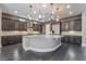 A kitchen boasting dark cabinets, stainless steel appliances, a large island with granite countertops and hardwood floors at 2804 Josephine Dr, Henderson, NV 89044