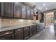 A kitchen with dark brown cabinets, light granite countertops, tile backsplash, and stainless steel appliances at 2804 Josephine Dr, Henderson, NV 89044