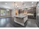 A kitchen featuring an island with granite countertop, stainless steel appliances, dark cabinetry and hardwood floors at 2804 Josephine Dr, Henderson, NV 89044