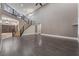 Spacious living room featuring dark wood floors, a staircase with iron railings, and a bookcase at 2804 Josephine Dr, Henderson, NV 89044