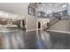 Open-concept living room featuring dark wood floors, iron stair railings, and modern lighting at 2804 Josephine Dr, Henderson, NV 89044
