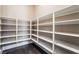 Walk-in pantry with white shelves and dark hardwood flooring, providing ample storage space at 2804 Josephine Dr, Henderson, NV 89044