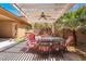 Covered patio features a ceiling fan and a dining set, perfect for outdoor entertaining at 2804 Josephine Dr, Henderson, NV 89044