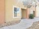 Exterior view of the home showing the front door, window, and landscaping at 3843 Terrazzo Ave # 0, Las Vegas, NV 89115