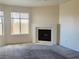 Bright living room with large windows, a fireplace, and neutral carpet flooring at 3843 Terrazzo Ave # 0, Las Vegas, NV 89115