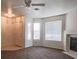 This living room has a large ceiling fan, large windows, fireplace, and plush carpet at 3843 Terrazzo Ave # 0, Las Vegas, NV 89115
