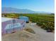 Expansive aerial view of Gilcrease Orchard showing rows of crops and surrounding buildings at 6615 Whispering Sands Dr, Las Vegas, NV 89131