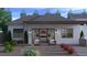 Charming covered patio space with comfortable seating and a view of the well-maintained backyard at 6615 Whispering Sands Dr, Las Vegas, NV 89131