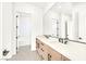 Elegant bathroom featuring double sinks, modern fixtures, and a view into the shower and tub at 6615 Whispering Sands Dr, Las Vegas, NV 89131