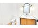 Powder bathroom with black faucet, white sink, and rustic wooden cabinet at 6615 Whispering Sands Dr, Las Vegas, NV 89131