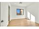 Simple bedroom featuring hardwood floors, white walls and modern window at 6615 Whispering Sands Dr, Las Vegas, NV 89131