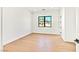 Bright bedroom with hardwood floors, white walls and a black frame window at 6615 Whispering Sands Dr, Las Vegas, NV 89131