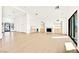 Open concept living room with fireplace, hardwood floors, and mini bar at 6615 Whispering Sands Dr, Las Vegas, NV 89131