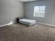 Bright bedroom with plush carpet and a bed, featuring neutral paint and a bright window at 5371 Brevin Ct, Las Vegas, NV 89131