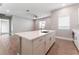 Kitchen island features modern countertops and stylish cabinetry, seamlessly flowing into the living area at 5371 Brevin Ct, Las Vegas, NV 89131