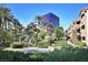 Landscaped grounds and lush greenery with a view of a modern building against a blue sky, creating a serene atmosphere at 4200 S Valley View Blvd # 1077, Las Vegas, NV 89103