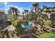 Resort-style pool surrounded by tropical palm trees, lounge chairs, and well-manicured landscaping at 4200 S Valley View Blvd # 1077, Las Vegas, NV 89103