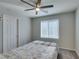 Bedroom featuring a ceiling fan, window with blinds, carpet, and a standard closet door at 4323 Creekside Cavern Ave, North Las Vegas, NV 89084