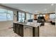 Open concept kitchen with an island, granite countertops, stainless steel appliances, and tile flooring at 4323 Creekside Cavern Ave, North Las Vegas, NV 89084