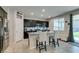 Kitchen with an island, dark cabinets, stainless steel appliances, and a decorative 'Kitchen' sign at 4323 Creekside Cavern Ave, North Las Vegas, NV 89084