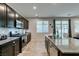 Kitchen featuring a stove and oven, stainless steel appliances, dark cabinets, and tile flooring at 4323 Creekside Cavern Ave, North Las Vegas, NV 89084
