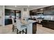 Kitchen island featuring a sink, stainless appliances, dark wood cabinetry, and bar stool seating at 4323 Creekside Cavern Ave, North Las Vegas, NV 89084