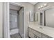 Bathroom features a vanity and tub with glass doors at 4860 Nara Vista Way # 104, Las Vegas, NV 89103
