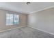 This neutral toned bedroom has a large window for natural light and comfortable carpet at 4860 Nara Vista Way # 104, Las Vegas, NV 89103