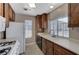 Bright kitchen featuring wood cabinets and white appliances at 4860 Nara Vista Way # 104, Las Vegas, NV 89103