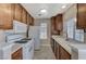 Kitchen showcasing classic wood cabinets, white appliances, and ample counter space at 4860 Nara Vista Way # 104, Las Vegas, NV 89103